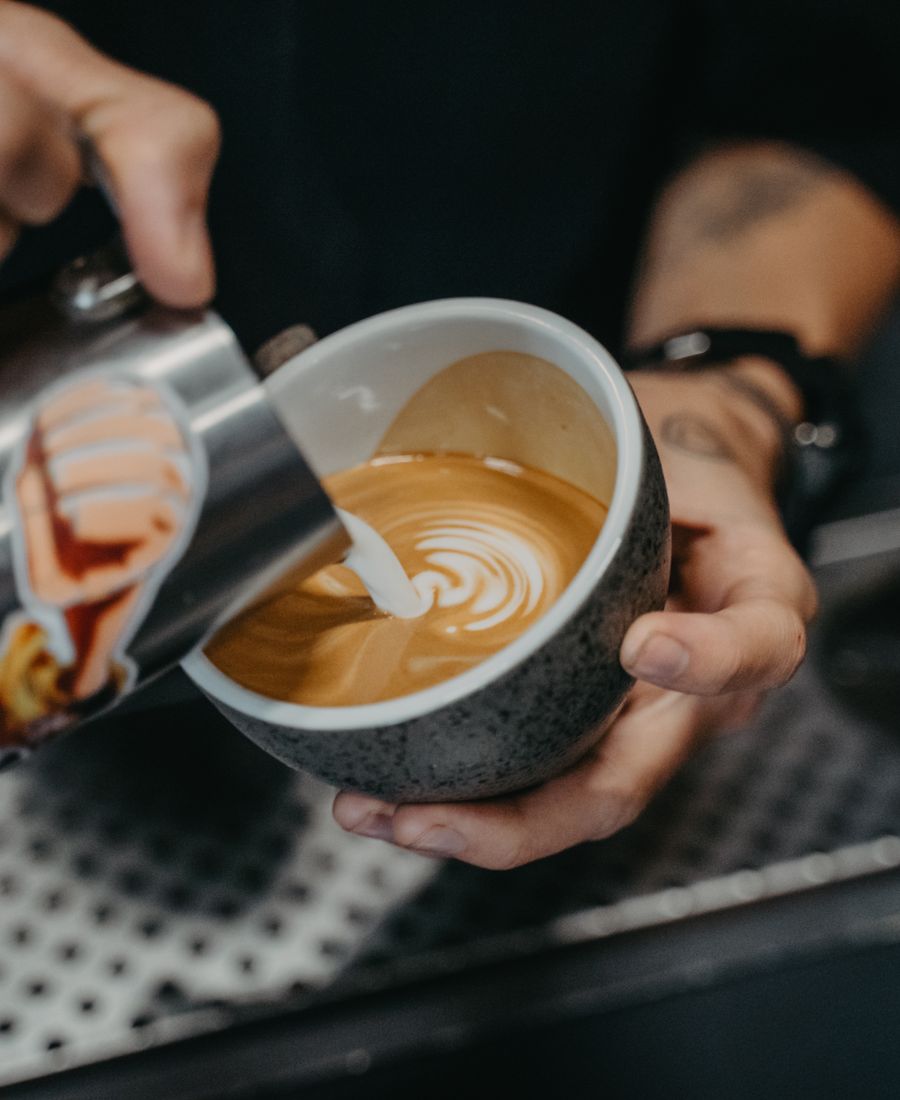 Our barista pouring a flat white